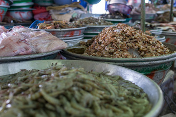 Big barrels with different freshwater prawns and shrimps on a local market in central america.