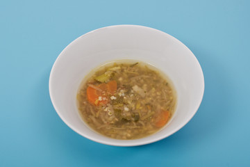 Miso vegetable soup with vegetables on a blue
