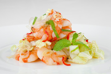 Large, beautiful shrimp with salad on a white plate.