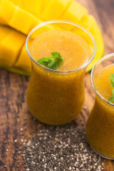 Fresh mango smoothie in glass with chia seeds