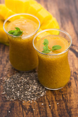 Fresh mango smoothie in glass with chia seeds