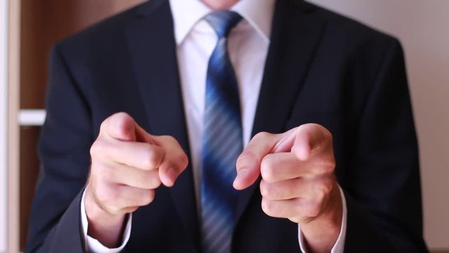 Male forefingers of both hands pointing