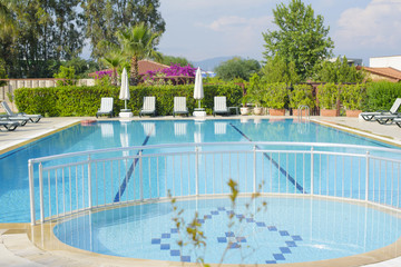 recreation area with swimming pool and sun beds