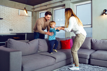 Obraz premium A happy family is playing with a child in the room.