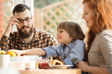 Happy family eating breakfast