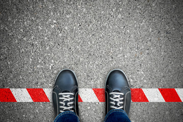 Fototapeta Black shoes standing on the red-white line obraz