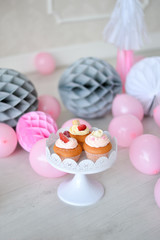 One year birthday Cake. Cake for holiday party. a lot of balloons pink and grey colors. 