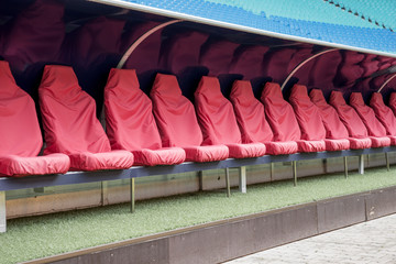 Naklejka premium Detail of red Reserve chair and staff coach bench in sport stadium