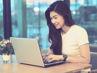 Happy Business Asian woman working with laptop and looking in monitor smile and have positive emotional,Business Startup Concept