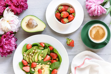 breakfast vegan salad with avocado, strawberries, pine nuts