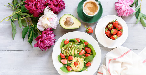 breakfast vegan salad with avocado, strawberries, pine nuts