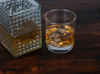 whisky on the rock on wood and wood background