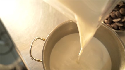 Ice-cream production. Mix ice cream. Pour the milk into a pan