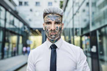 Young businessman with tattooed face