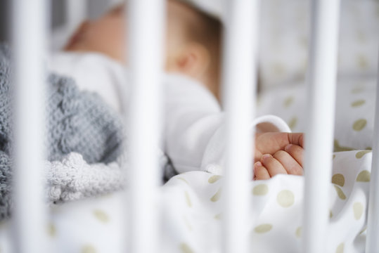 Defocused shot of baby lying in crib
