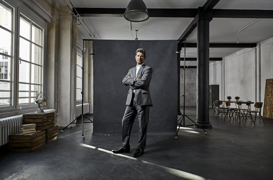 Portrait of mature businessman in front of black backdrop