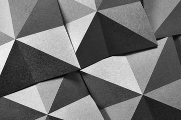 Geometric shapes of paper in black and white, grainy paper texture