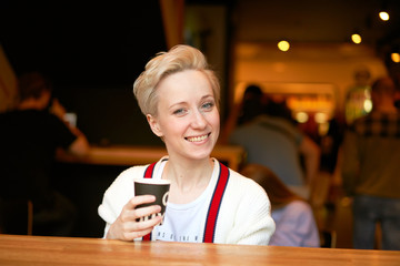 girl drinking coffee in a cafe