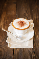 Hot coffee cappuccino isolated on wooden table
