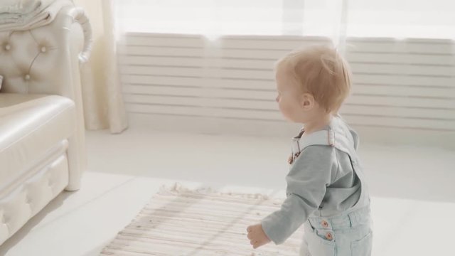 Little lovely baby take her bottle and drink. Happy family. Slow motion