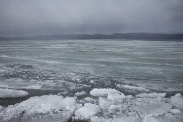 Spring lake with melting ice