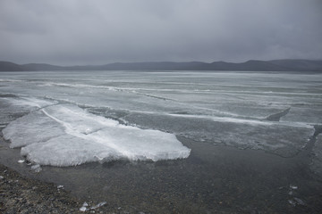 Spring lake with melting ice