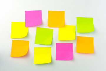 Collection of different colored sheets of note papers the stick on the wall, ready for your message.