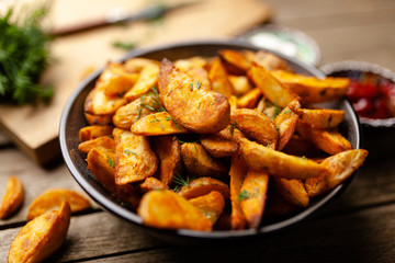 Baked potato fries on wooden table