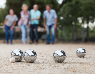 Males and females playing petanque