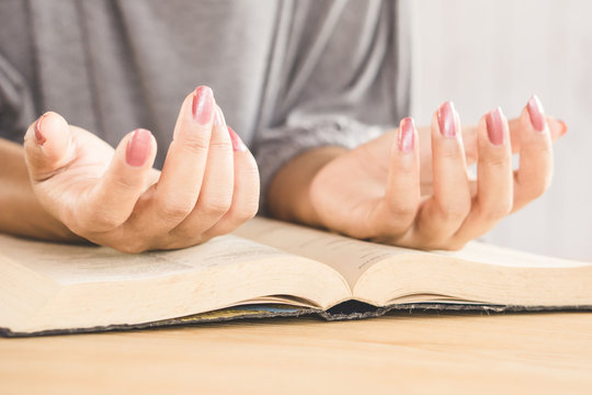 beautiful woman hand praying peaceful in church with bible book on desk 
