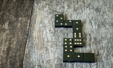 domino pieces on the brown wooden table