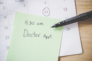doctor appointment remind note on calendar with date and time for examination 