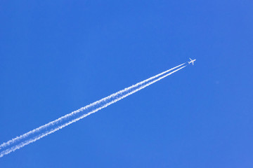 white vapor trail from the jet plane on blue sky