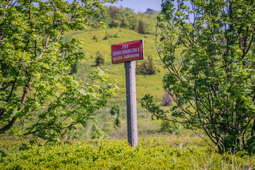 Fototapeta premium Warning sign 'Border zone - entry is not allowed' - on a Poland and Ukraine border in Bieszczady Mountains National Park, Poland