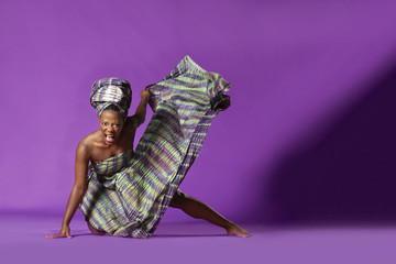 Beautiful African Black girl wearing traditional colorful African outfit does a dramatic aggressive...