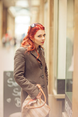 Fototapeta premium Beautiful young woman shopping in the city, mall with shopping bag, happy shopping tour 