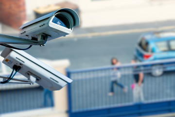 security CCTV camera or surveillance system with street on blurry background