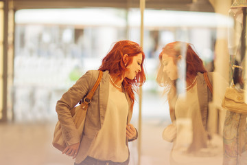 Beautiful young woman shopping in the city, mall with shopping bag, happy shopping tour 