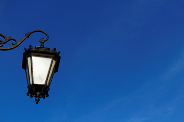 Fototapeta na wymiar Vintage lantern on the street and blue sky