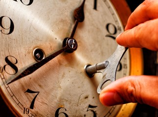 A watchmaker who writes a vintage clock