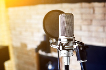 Silver condenser microphone. Music studio.
