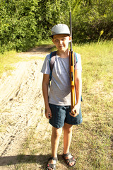 boy, teenager with a gun on his shoulder, standing on the road