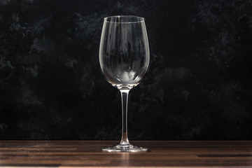 wine glass on the wooden table with dark background