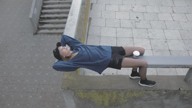 Beautiful young gitl woman relaxing at street. City urban style. Slow motion video shooting by handheld gimbal