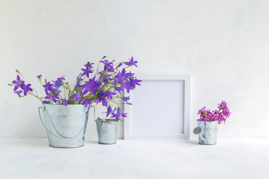 Mockup with a white frame and summer flowers