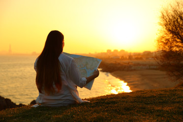 Tourist reading a map searching location