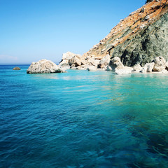 Rocky shore. Southern coast of Turkey. Calm blue sea and clear sky. Small beach on the island near Adrasan. Rocky shore. View of Mediterranean Sea. Spring sunny day in Antalya province, Turkey.