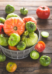 Fresh organic tomatoes on wooden table 