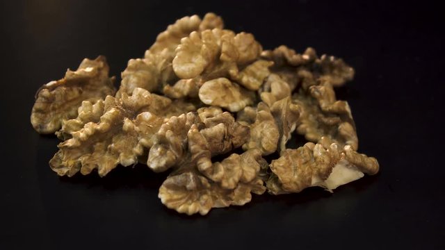 Walnuts in shell and without shell on a black background
