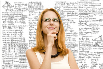 Young redhead woman with math formulas on background.